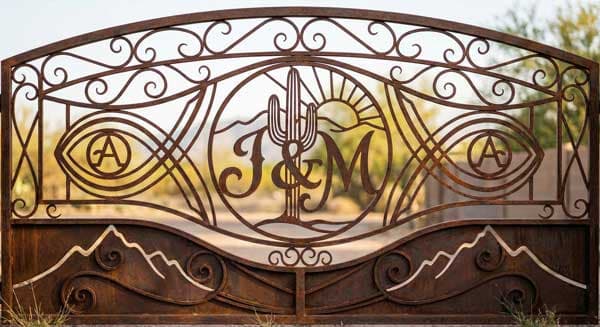 Custom scrollwork iron gate with personalized design elements and Arizona desert motifs in Scottsdale