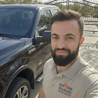 Licensed Phoenix gate repair technician installing a LiftMaster motor in Scottsdale, AZ
